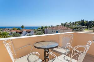 a balcony with a table and chairs and a view at Vanas Apartments in Spetses