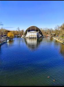 a bridge over a river with ducks in the water at Апартаменти Оперний театр у самому Центрі in Dnipro +15 photos