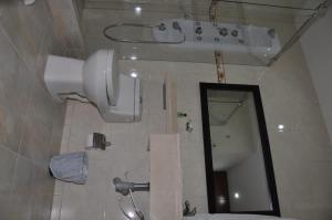 a bathroom with a shower and a sink and a mirror at Apartamentos Plaza Modelia in Bogotá