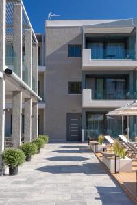 an external view of a building with a courtyard at KN Ionian Suites in Nikiana