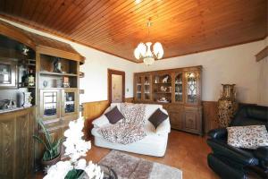 a living room with a white couch and a chair at Casa Rural do Salgueirinho in Santo Tirso