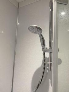 a shower with a shower head in a bathroom at Appletree in Hugh Town