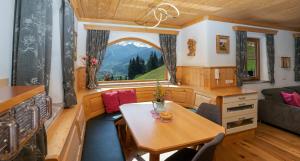 a tiny house with a table and a window at Chalet Schröckgut in Bad Hofgastein