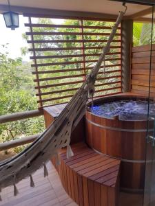 a hammock on a hot tub on a deck at Villas do Pratagy in Maceió