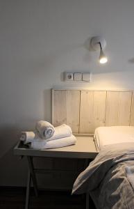 a bedroom with a bed and towels on a desk at St. Prokop Luxury Apartments 256 in Boží Dar