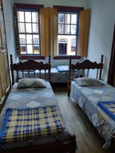 En eller flere senge i et værelse på Pousada Dona Dazinha