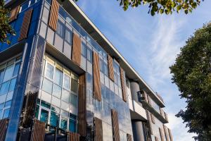 a building with glass windows on the side of it at Hotel IN in Banja Luka