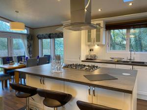 a kitchen with a large island with a counter top at Fairhaven lodge Free Wifi & Hottub in Warton