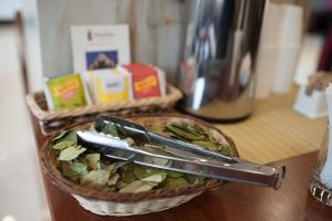 a basket of food with tongs on a table at Royal Inn Cusco Hotel in Cusco