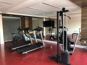 a gym with several tread machines in a room at Flat Granja Viana - espaço e conforto in Cotia