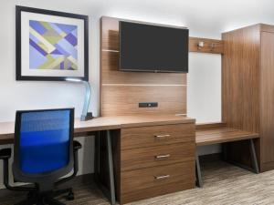an office with a desk with a computer and a tv at Holiday Inn Express & Suites - Kokomo South, an IHG Hotel in Kokomo