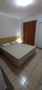 a large bed in a room with a tiled floor at FLAT NO MELHOR DO RIO QUENTE 800m HOT PARK in Rio Quente