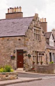 an old stone building on the side of a street at Anchorage B&B in Cockenzie