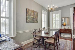 a dining room with a wooden table and chairs at 125 Church in Charleston