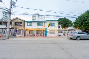 a car parked in front of a house with a fence at Hotel Ayenda Cartagena Blue 1804 in Cartagena de Indias