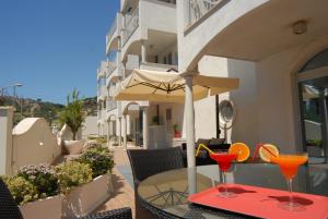 a table with two martini glasses on top of it at Residence Costa Smeralda in Grottammare