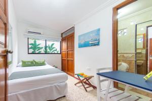 Postel nebo postele na pokoji v ubytování Hotel Ayenda Casa Cano 1805