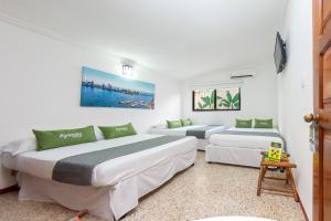 Postel nebo postele na pokoji v ubytování Hotel Ayenda Casa Cano 1805