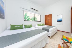 Postel nebo postele na pokoji v ubytování Hotel Ayenda Casa Cano 1805