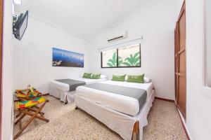 Postel nebo postele na pokoji v ubytování Hotel Ayenda Casa Cano 1805