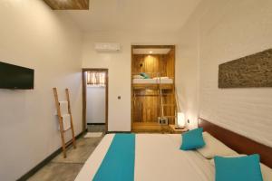 a bedroom with a bed and a desk at Echoland Boutique Bed And Breakfast in Canggu