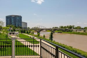 a bridge over a river with a train on it at FRONTDESK LC Riversouth 205 Apts Downtown Columbus in Columbus