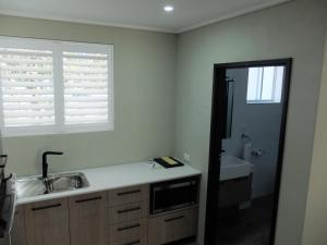 a kitchen with a sink and a window at Barooga River Gums Motor Inn in Barooga +20 photos
