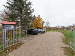a driveway with two cars parked next to a fence at Vacation apartment in Usedom on the Baltic Sea in Stolpe auf Usedom