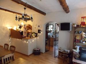 a living room with a dining table and a tv at Hotel Talburg in Heiligenhaus