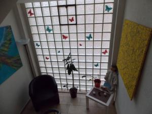 a child sitting on a table in front of a window at Hotel Talburg in Heiligenhaus