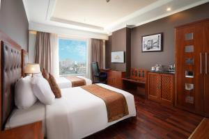 Giường trong phòng chung tại Samdi Da Nang Central Hotel