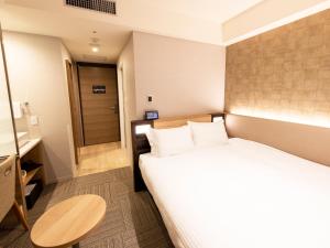 Postel nebo postele na pokoji v ubytování Kawagoe Tobu Hotel