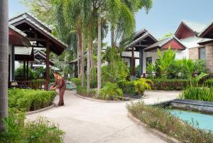 een man die voor een resort staat bij The Zign Hotel in Noord Pattaya