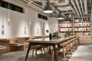 REF Omiya by VESSEL HOTELS في سايتاما: غرفة طعام كبيرة مع طاولة وكراسي