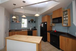a kitchen with a black refrigerator and wooden cabinets at 216 New Castle St. in Rehoboth Beach