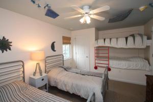 a bedroom with two bunk beds and a ceiling fan at 216 New Castle St. in Rehoboth Beach