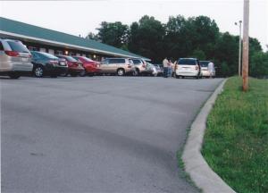 a parking lot with cars parked in front of a building at Deerfield Inn in Greenbrier