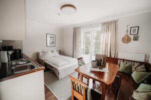 a kitchen and living room with a table and a couch at EnjoyTheAlps - Appartements BARBARA in Flachau
