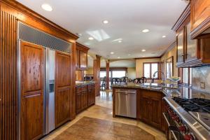 a large kitchen with wooden cabinets and stainless steel appliances at 317 Carnation, Corona del Mar in Newport Beach