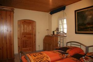 a bedroom with two beds and a window and a door at FEWO-im-sanierten-Fachwerkhaus in Müglitztal +9 photos