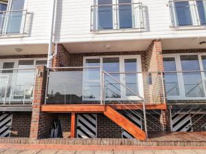 a house with a staircase on the side of it at 3 Tidal in Rye