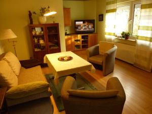 a living room with a couch and a table and chairs at Fewo-Fuchshain in Fuchshain