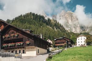 a village in the mountains with a mountain at Ciasa Altonn in Colfosco