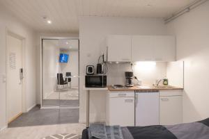 a kitchen with white cabinets and a counter top at Easy Housing Raahe in Pattijoki