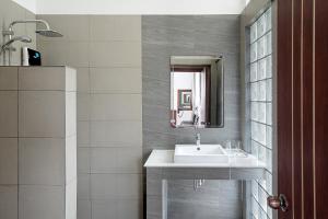 a bathroom with a sink and a mirror at Sandy Residence Sihanoukville in Sihanoukville