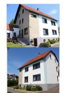 une maison blanche avec un toit rouge dans l'établissement Ferienwohnung-im-Teutoburger-Wald, à Schieder-Schwalenberg