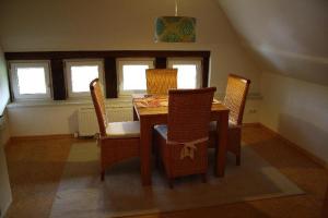 a dining room with a wooden table and chairs at Bauernhaus-am-Fluss in Berne