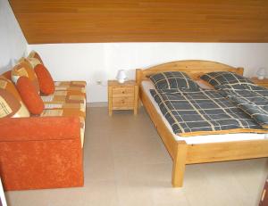 a bedroom with two beds and a night stand at Goldene-Linie-4-Taubennest in Wangerland