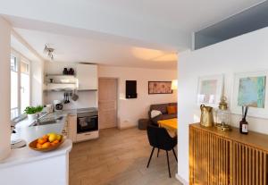 a kitchen and a living room with a table at Apartment Close to the Beach in Flensburg