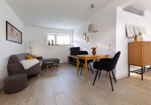 a living room with a table and chairs and a couch at Apartment Close to the Beach in Flensburg +15 photos